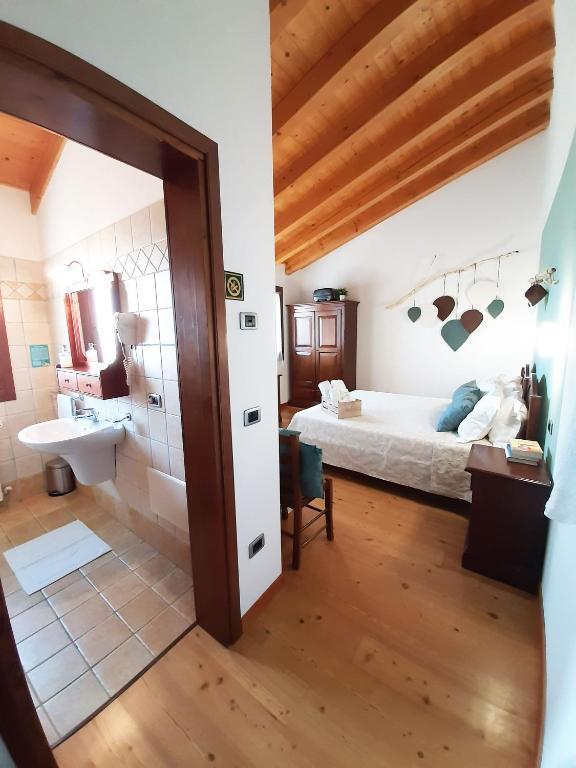 Postel nebo postele na pokoji v ubytování Agriturismo Le Cipressine