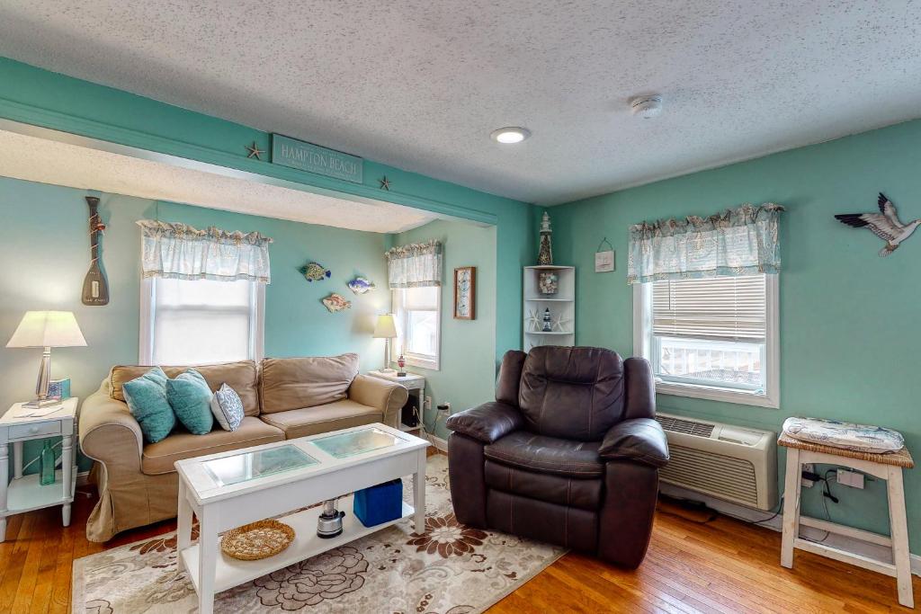 a living room with a couch and a chair at Hampton Beach Hangout & Nancy's Villa in Hampton