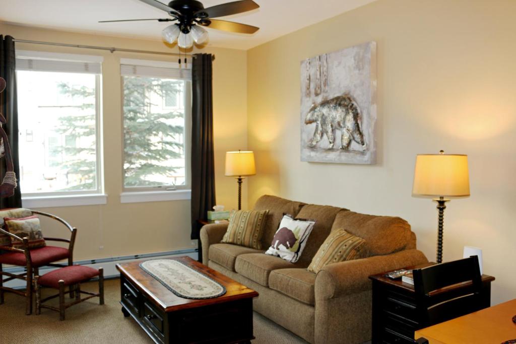 a living room with a couch and a table at Ski-In Ski-Out Modern Mountain Condo in Winter Park