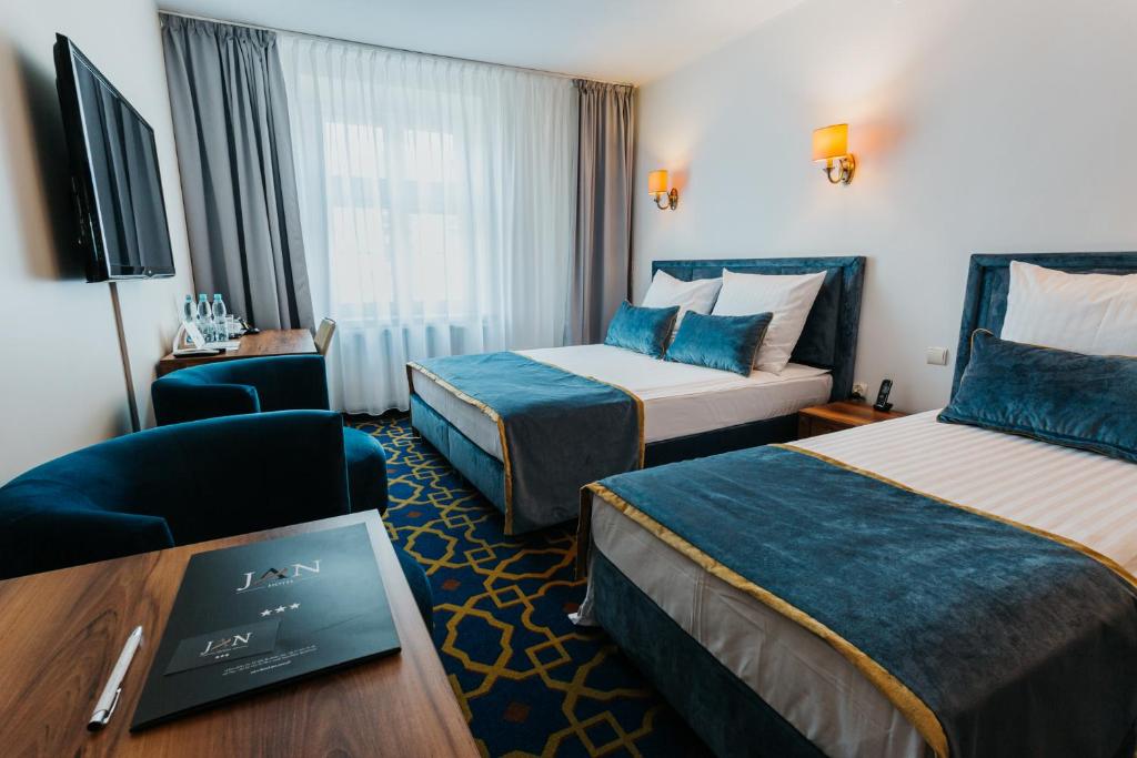 Postel nebo postele na pokoji v ubytování Hotel Jan