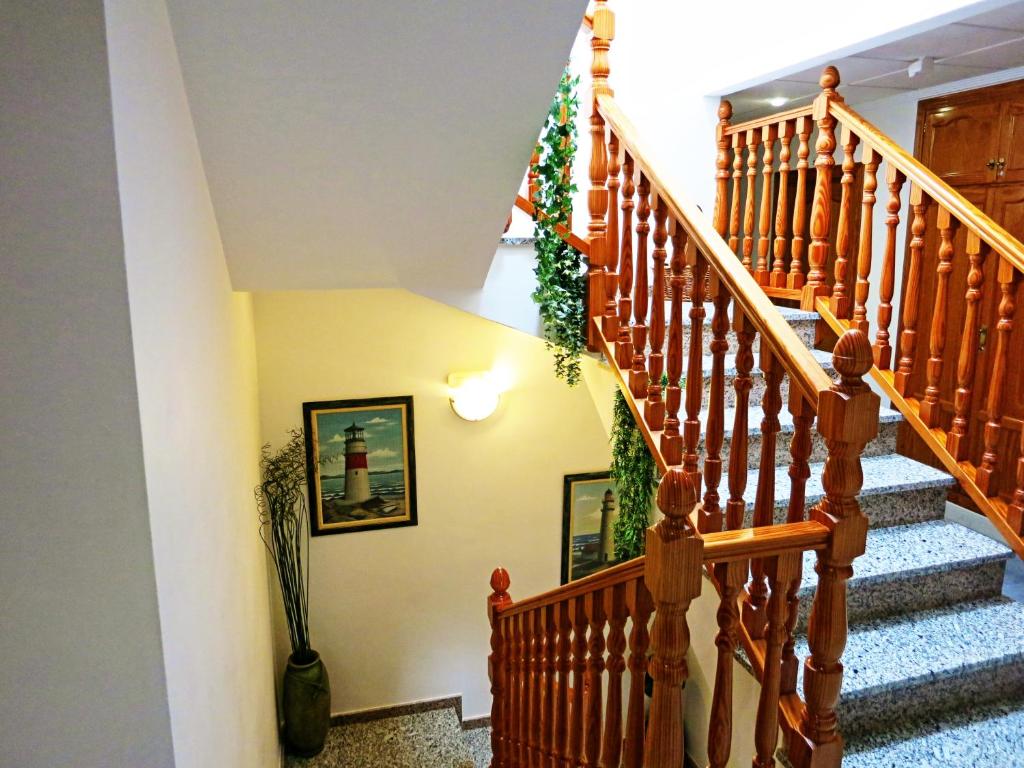 a staircase with a christmas wreath on the wall at Hostal Brisamar in San José