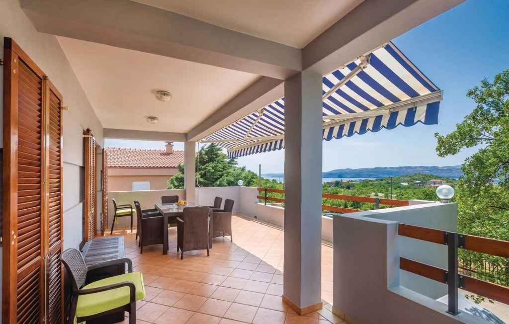a patio with a table and chairs on a balcony at Apartments Karlobag - Velebit Riviera 39571 in Karlobag