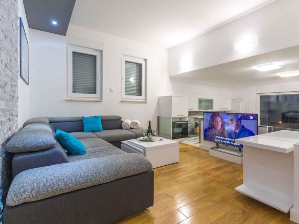 a living room with a couch and a flat screen tv at Apartment in Njivice&#47;Insel Krk 35106 in Njivice
