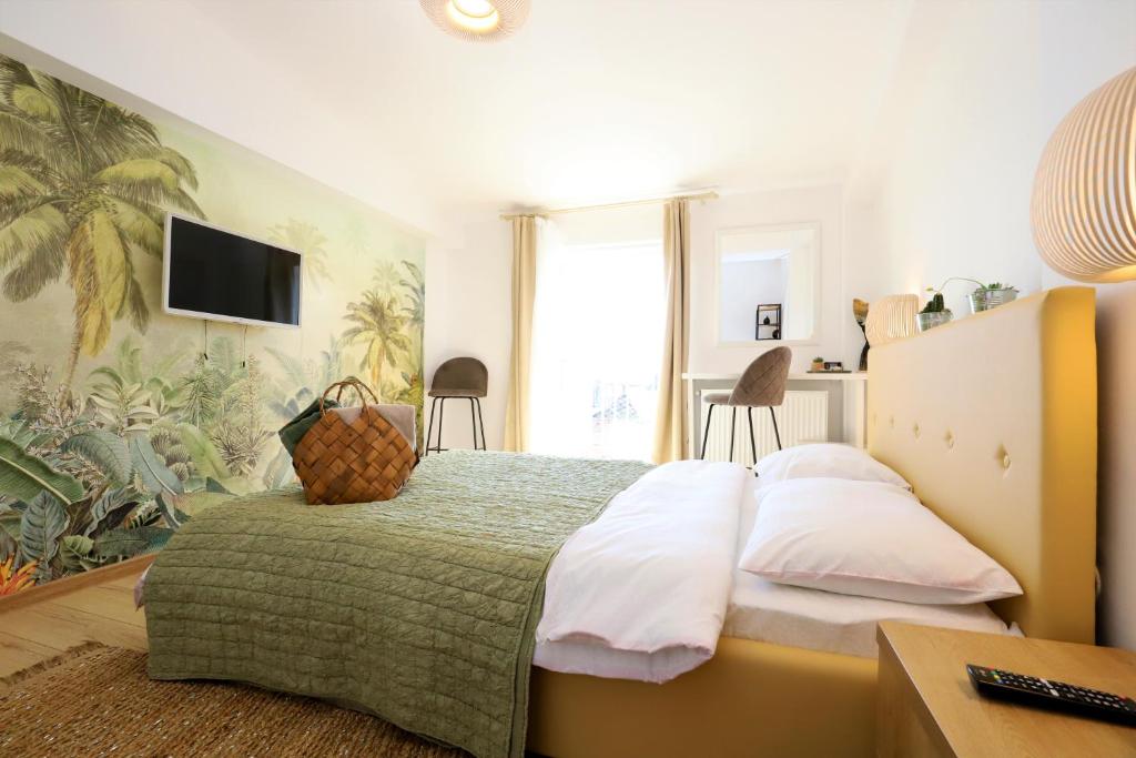 a bedroom with a large bed with a green blanket at Apartament Central "Casa D'Alba" in Alba Iulia
