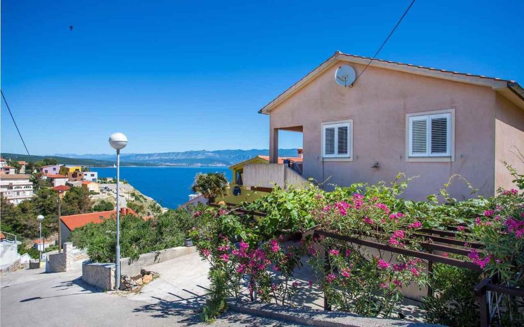 a house on the side of a hill with flowers at Apartment in Vrbnik/Insel Krk 36800 in Vrbnik