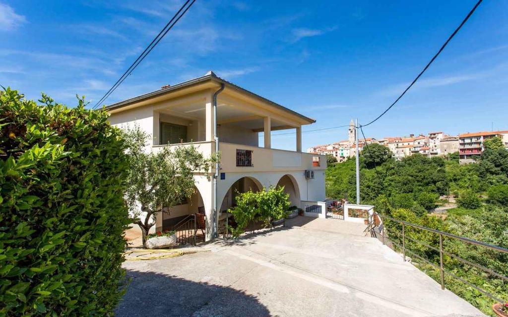 a small white house with a driveway at Apartment in Vrbnik/Insel Krk 36871 in Vrbnik