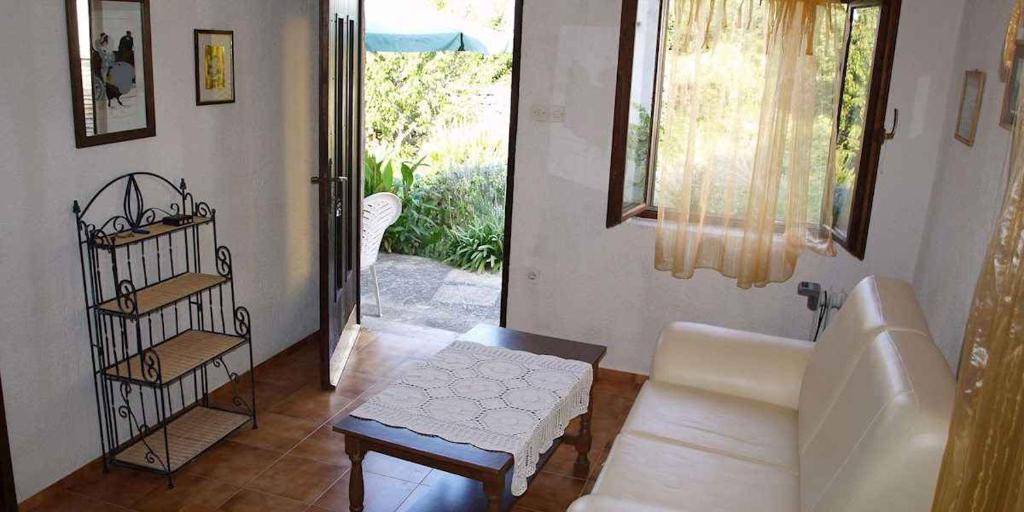a living room with a couch and a table at Apartment in Veli Losinj 36509 in Veli Lošinj