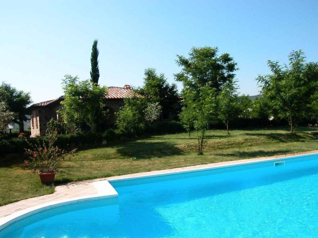 a swimming pool in front of a house at Holiday home in Montalcino/Toskana 24097 in Montalcino