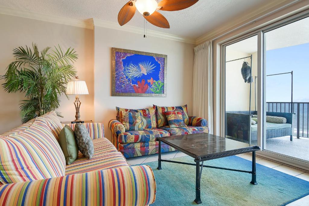 a living room with a couch and a table at Ocean Villa Condos #704 by Book That Condo in Panama City Beach