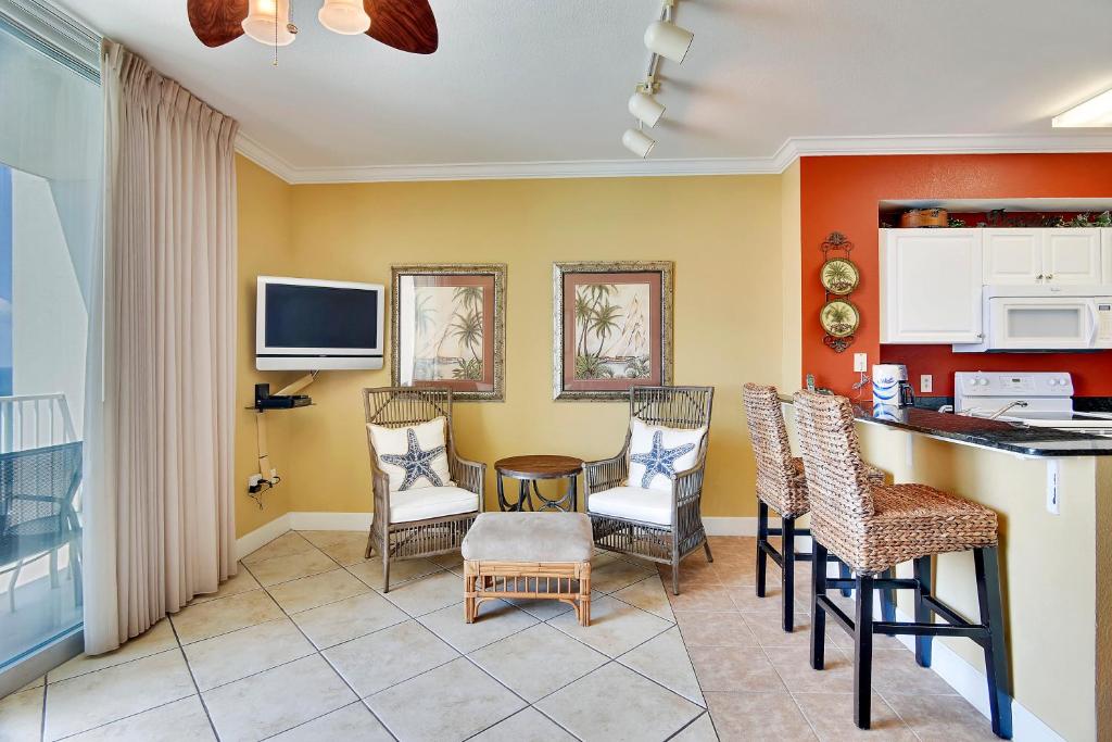 a kitchen and dining room with a table and chairs at Tidewater Beach Resort #2014 by Book That Condo in Panama City Beach
