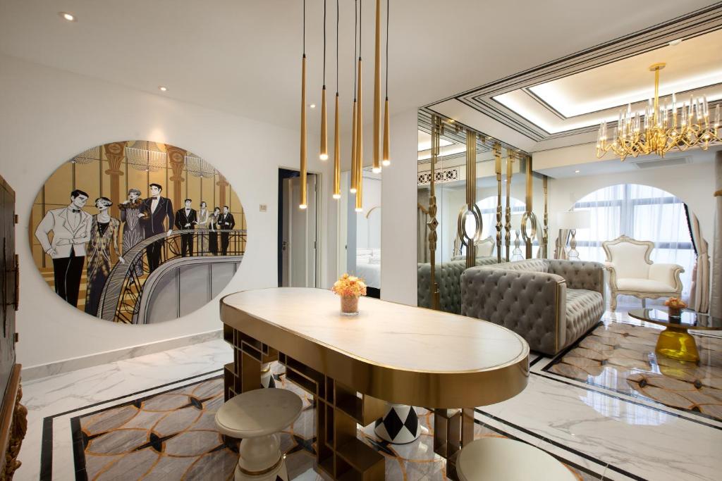 A polished shared lounge and work area with a long table, stools and decorative art.