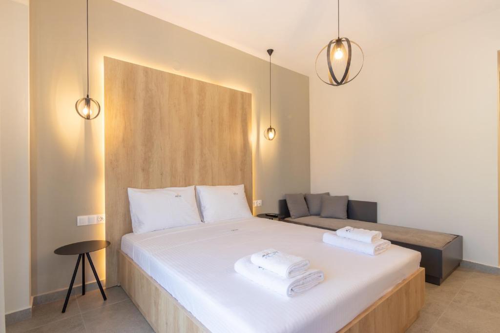 a bedroom with a white bed with two towels on it at MEDITERRANEO in Skala Potamias