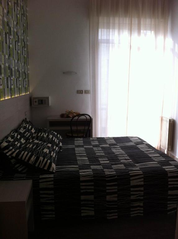A bed or beds in a room at Hotel Ave