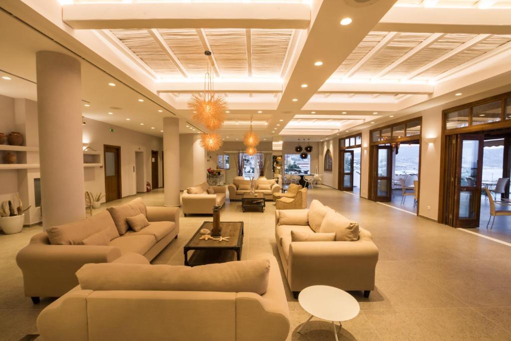 a large living room with couches and tables at Aegean Village Beachfront Resort in Amoopi