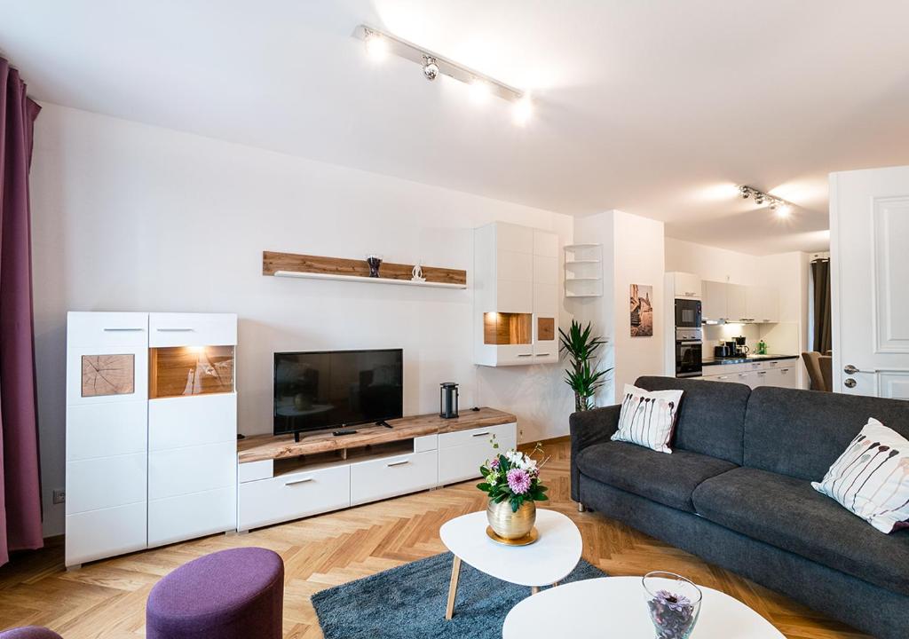 a living room with a couch and a tv at Familienapartment mit Blick zur Frauenkirche in Dresden