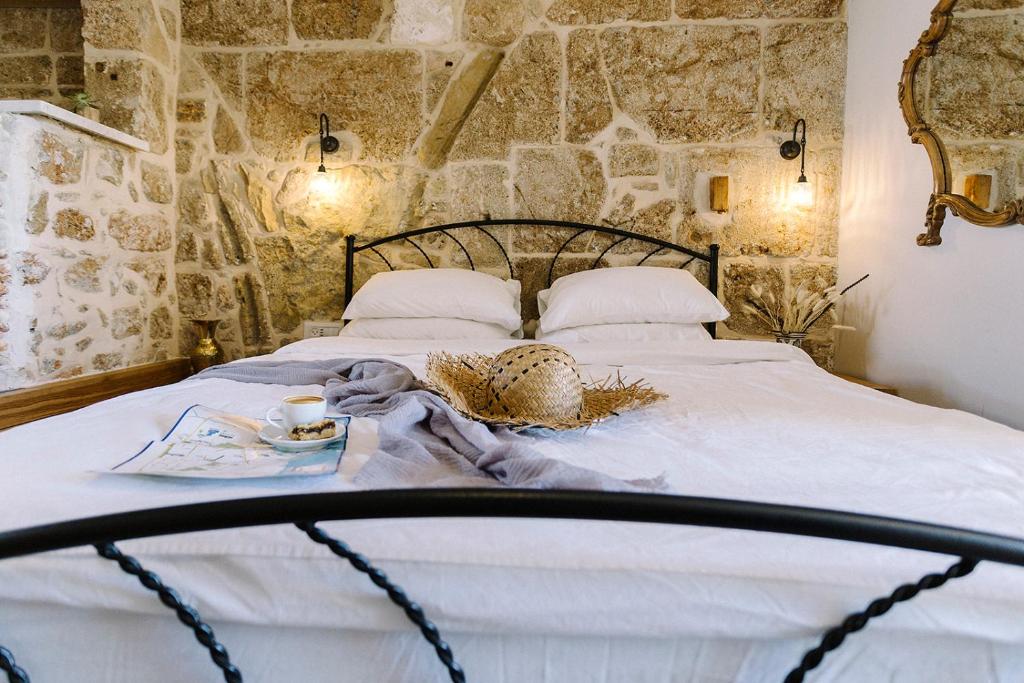 a bed in a room with a stone wall at Saint Anna Akko in ‘Akko