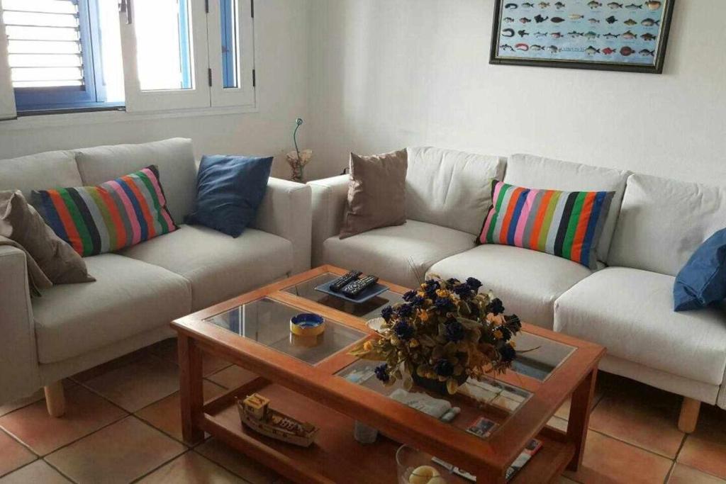 a living room with a couch and a coffee table at Famara Sweet Home in Famara