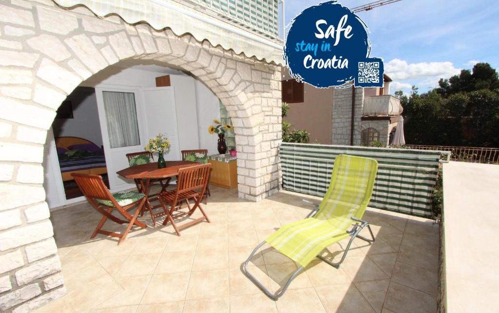 a patio with chairs and a table and a sign at Apartments Monpeloso in Rovinj