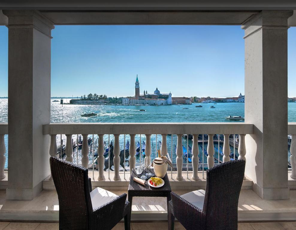 a table on a balcony with a view of the ocean at Londra Palace Venezia in Venice
