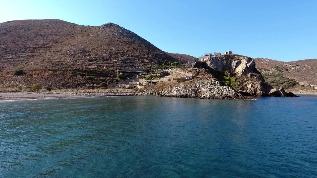 a body of water with a mountain in the background at Marmari Paradise Resort Hotel in Marmari