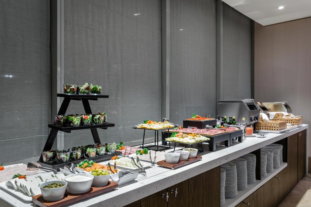 a buffet line with many different types of food at Eurostars Torre Sevilla in Seville