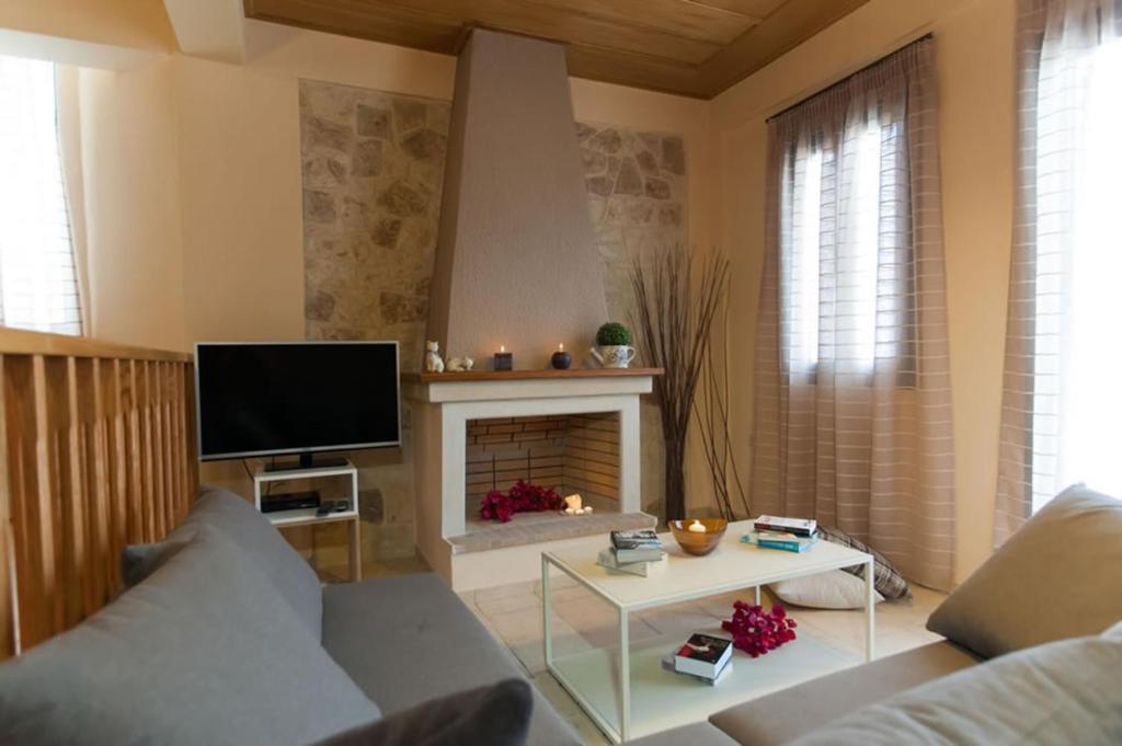 A television and/or entertainment centre at Peonia and Ortansia Villas - Few Steps from the beach