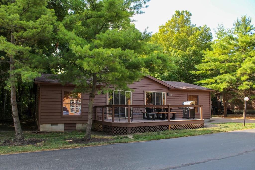 a small house with a porch on a street at Island Club #102 in Put-in-Bay