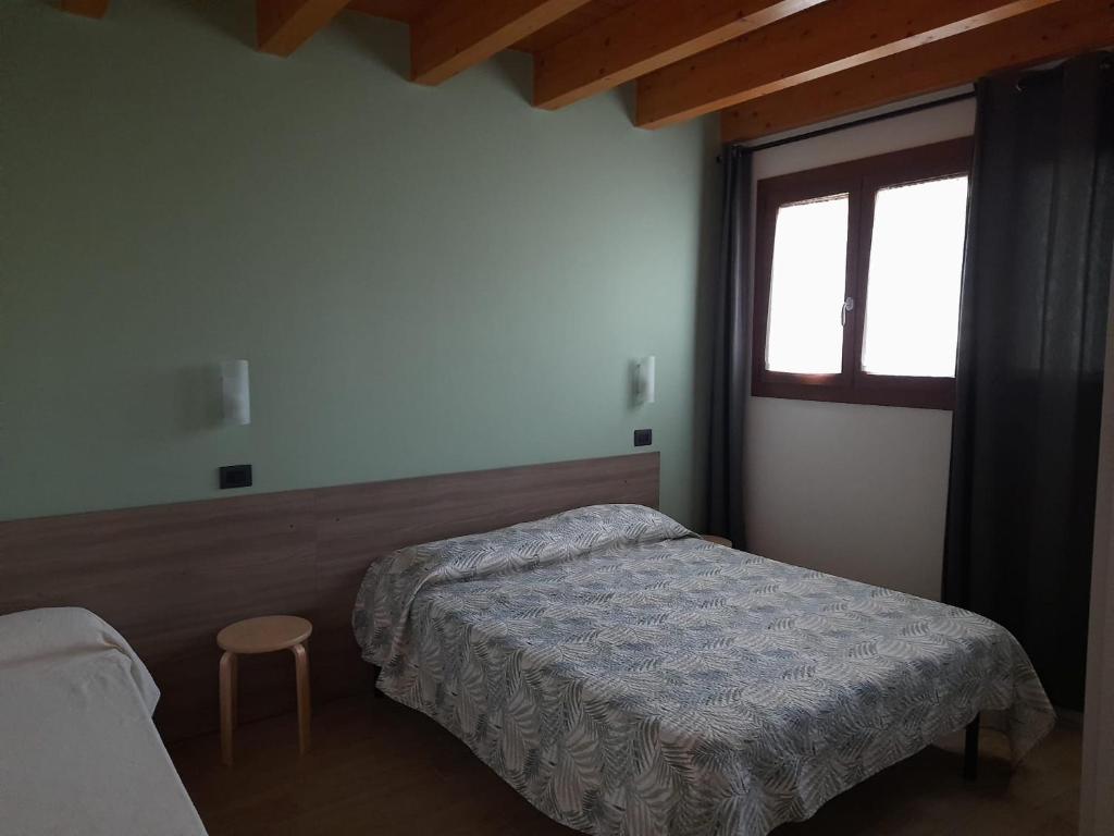 Postel nebo postele na pokoji v ubytování Agriturismo Ai Tre Fienili