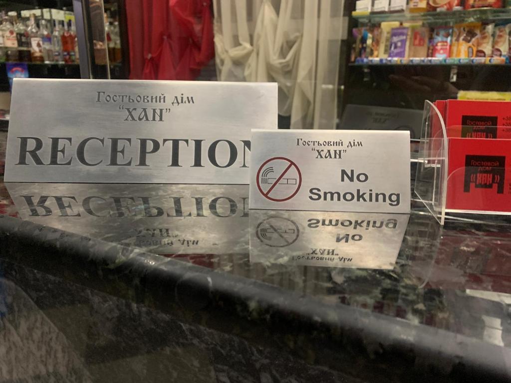 a couple of signs on a counter in a store at Хостел ХАН in Kharkiv