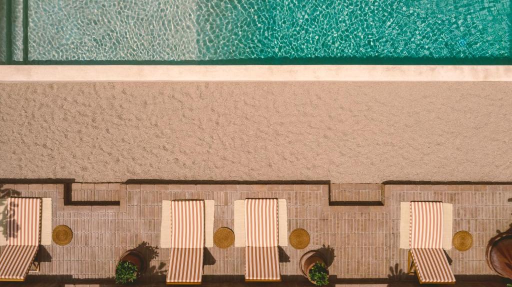 a model of a building with chairs and a pool at Baja Club Hotel, La Paz, Baja California Sur, a Member of Design Hotels in La Paz