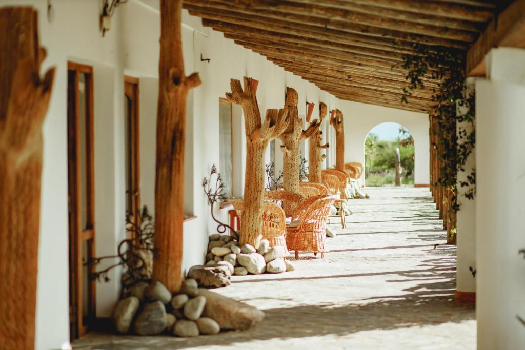 a hallway with a row of tables and chairs at Hotel Texas in Cafayate