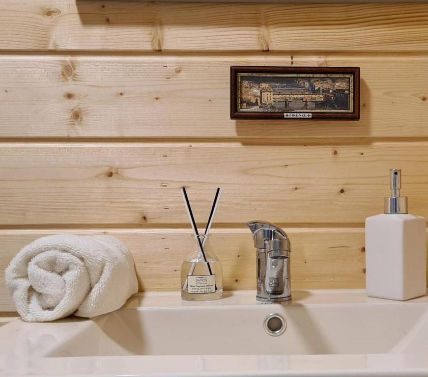 a bathroom sink with a towel and a toothbrush at Vida Bhermon 2, one small wooden cabin in Majdal Shams