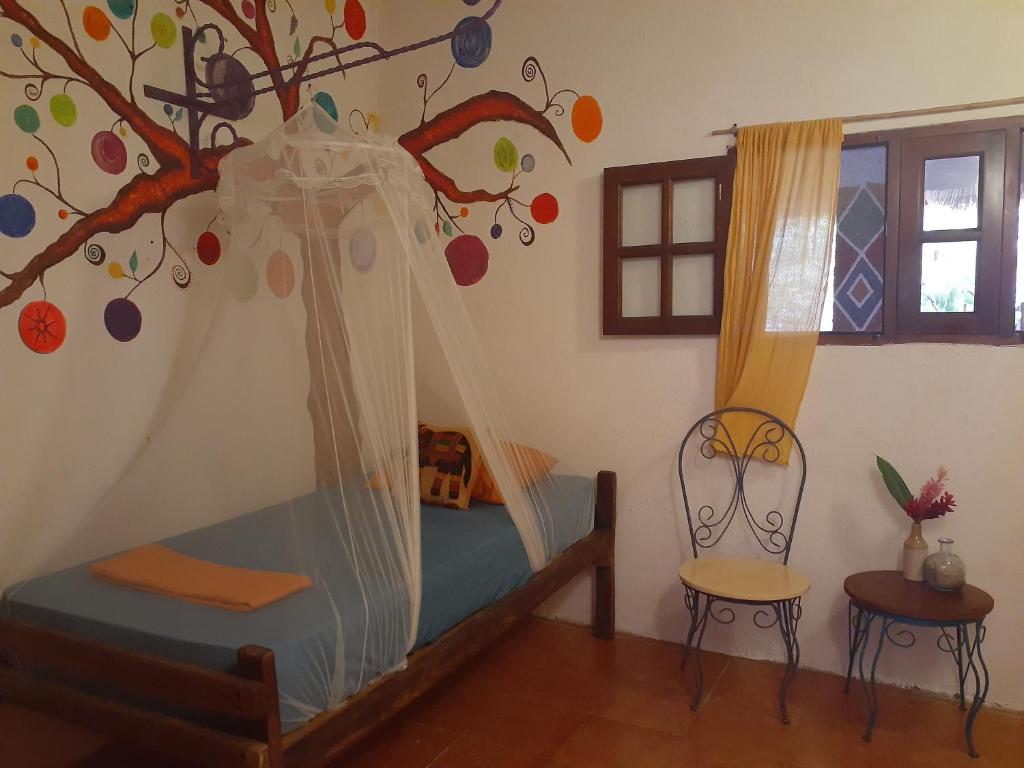 Una cama o camas en una habitación de Macondo Hostel