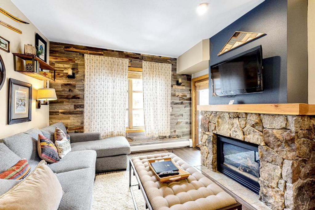 ein Wohnzimmer mit einem Steinkamin und einem TV in der Unterkunft Passage Point 521 in Frisco