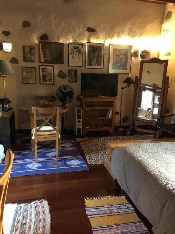 a bedroom with a bed and a table and a mirror at Vereda de Las Camellas in Puerto del Rosario