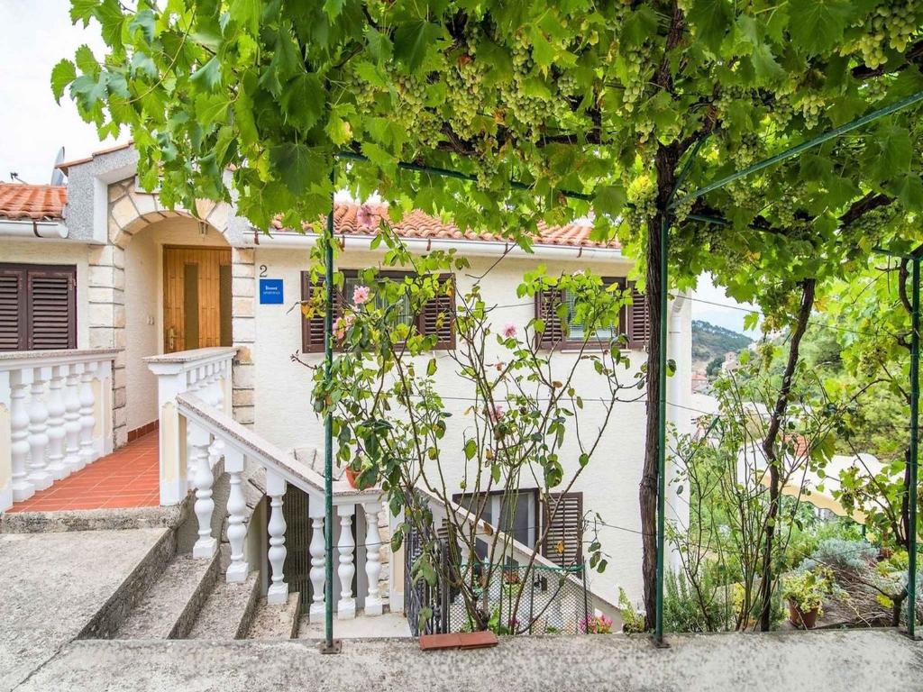 a white house with a staircase in front of it at Apartment in Vrbnik/Insel Krk 13622 in Vrbnik