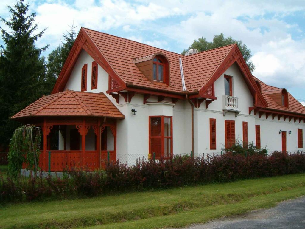 a white house with a red roof at Holiday home Balatonbereny 18059 in Balatonberény