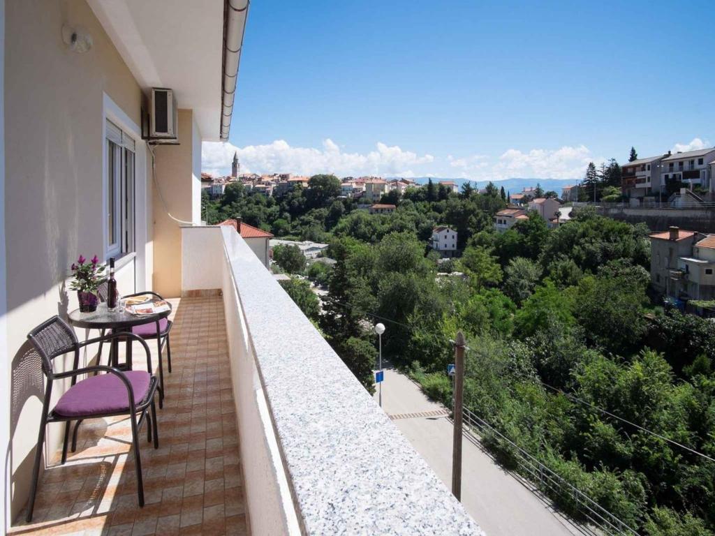 a balcony with a table and chairs and a view at Apartment in Vrbnik/Insel Krk 13610 in Vrbnik