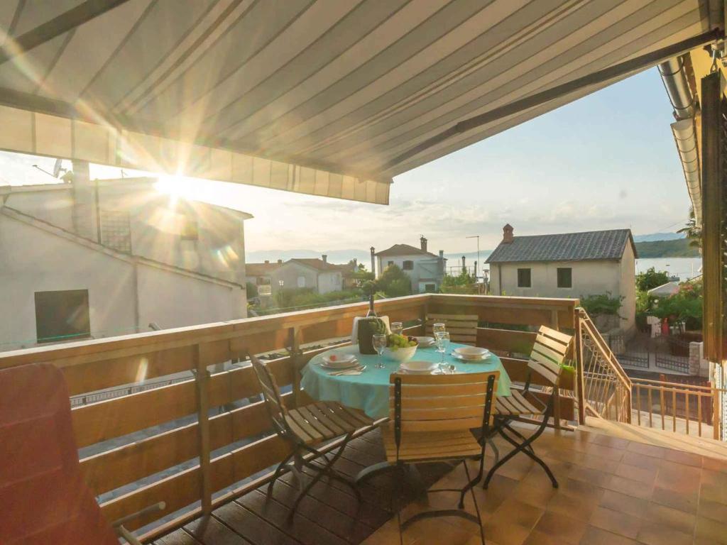 a patio with a table and chairs on a balcony at Apartment in Njivice/Insel Krk 27855 in Njivice