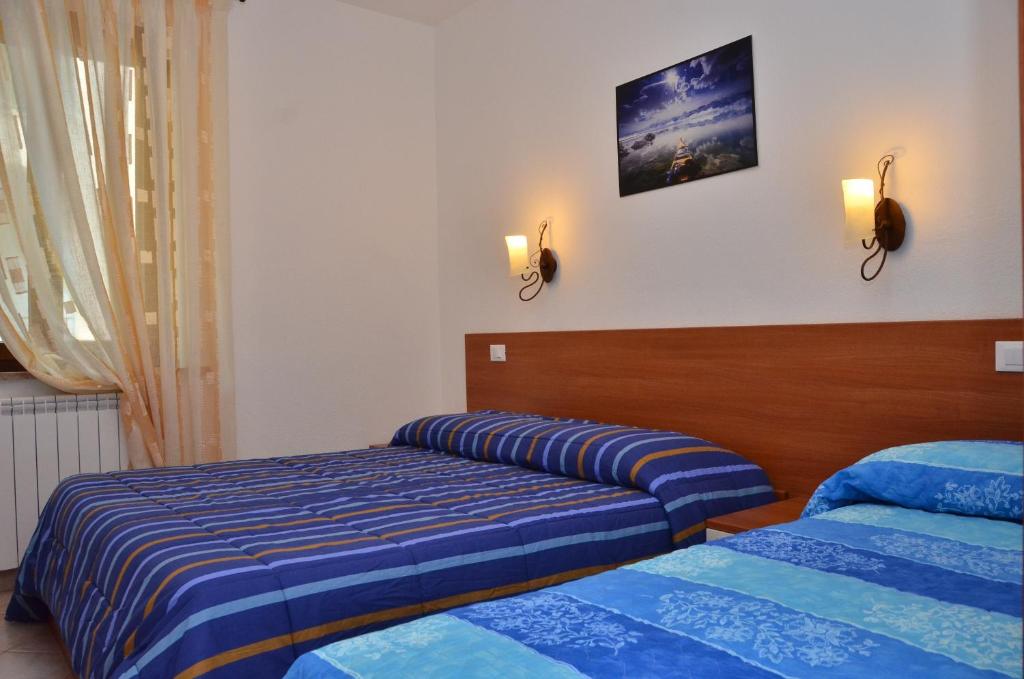 Postel nebo postele na pokoji v ubytování Domo - Guest-House Il Nespolo Fiorito