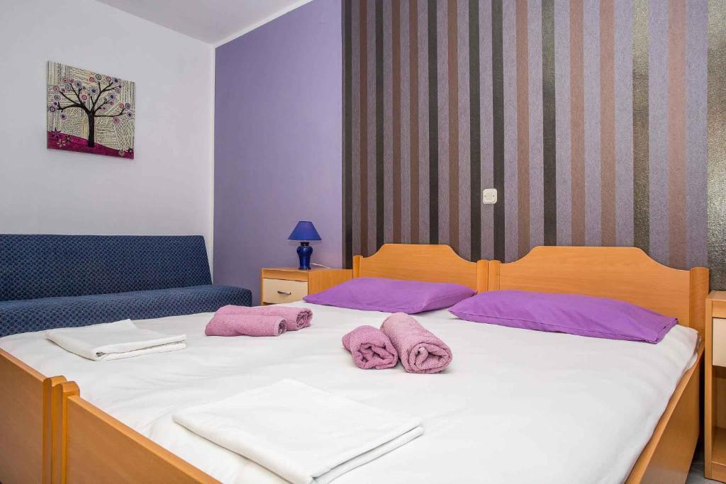 a bedroom with a bed with two pink towels on it at Apartment in Njivice/Insel Krk 13321 in Njivice