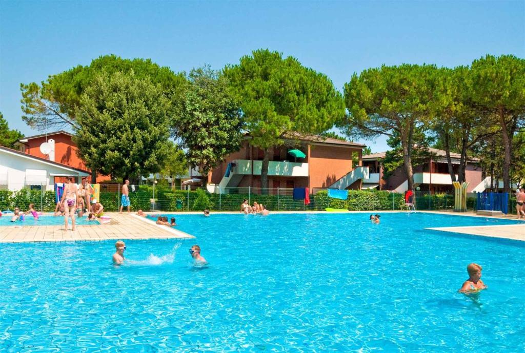 a group of people swimming in a swimming pool at Apartments in Bibione 24604 in Bibione