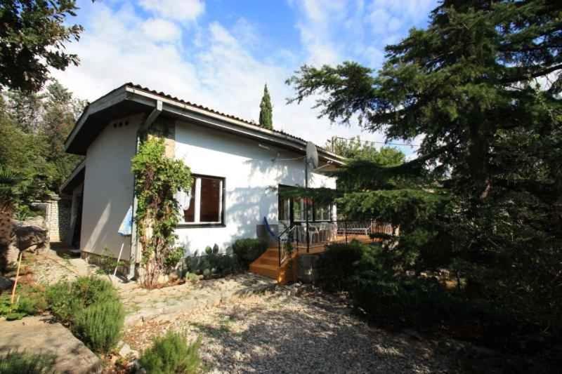 a small white house with a porch and trees at Holiday home in Crikvenica 5431 in Crikvenica