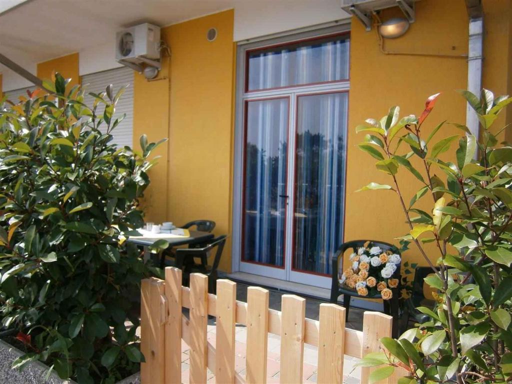 a wooden fence in front of a house with a window at Apartments in Bibione 24581 in Bibione