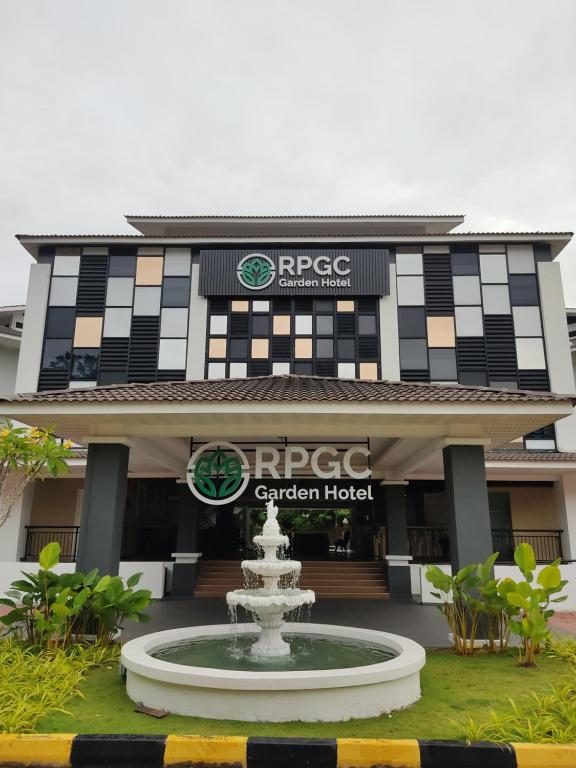 a building with a fountain in front of it at RPGC Garden Hotel in Ipoh