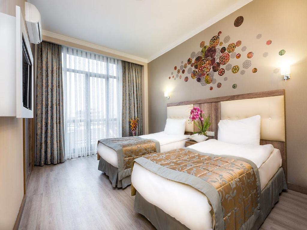 a bedroom with a large bed and a large window at Fatih Hotel Corner in Istanbul
