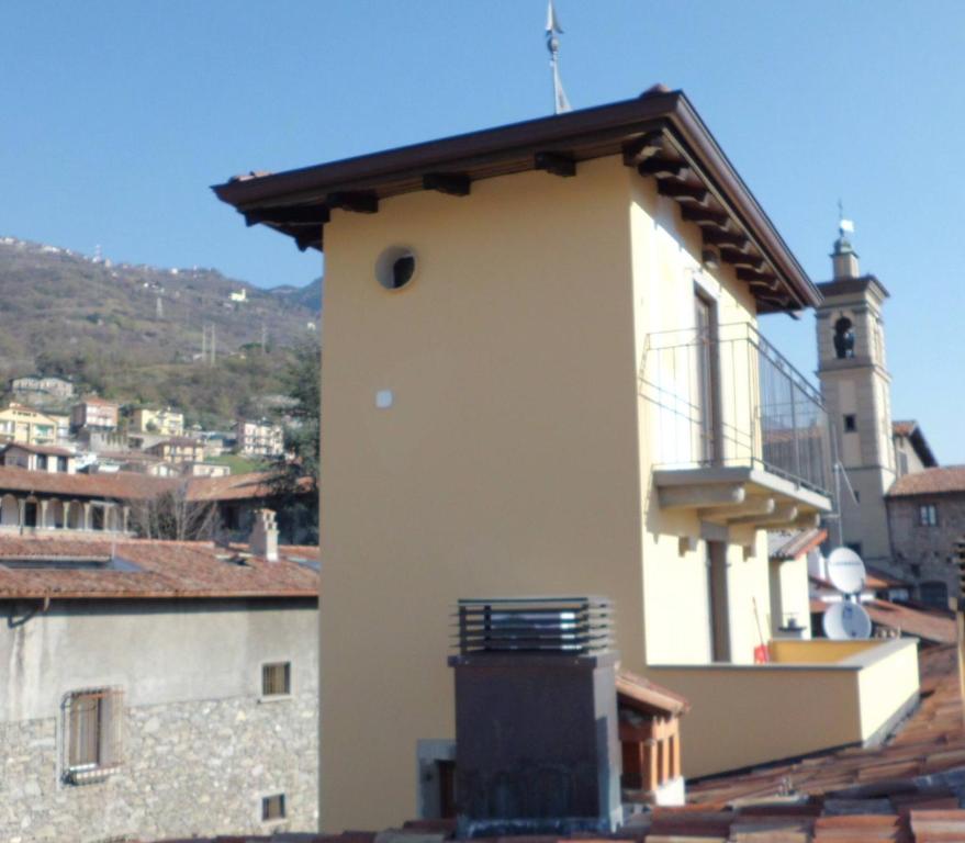 a white building with a clock tower in a city at Torre Antica - Lombardia, Italy in Lovere