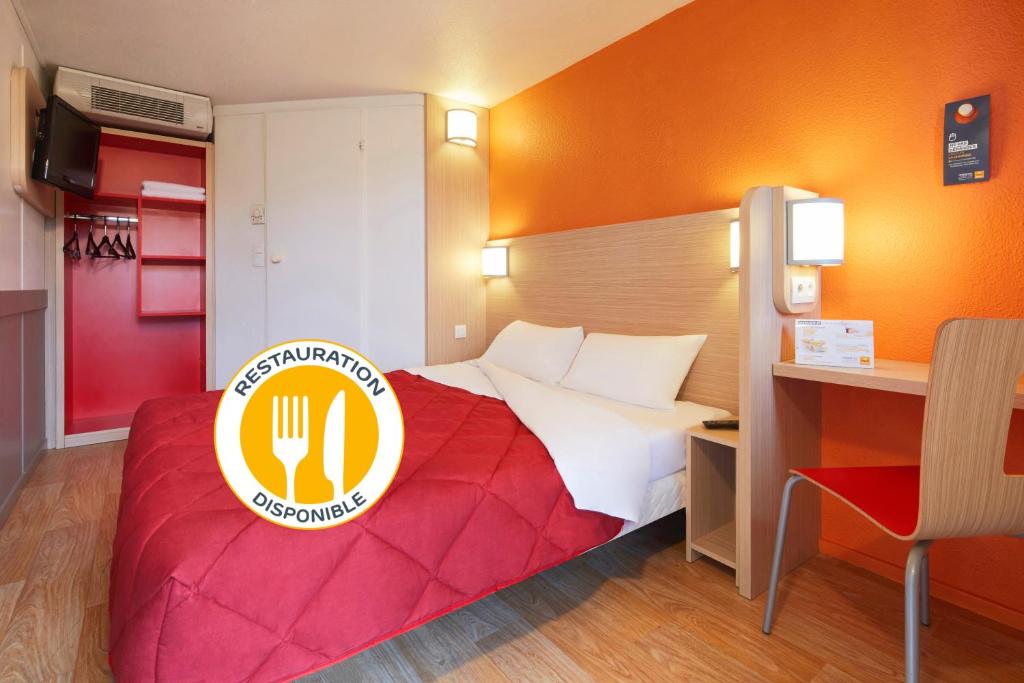 a hotel room with a bed with a sign on it at Premiere Classe Toulouse Sud - Portet in Portet-sur-Garonne