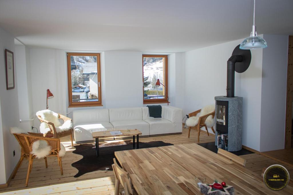 a living room with a white couch and a fireplace at Ferienwohnungen Haus Alte Bäckerei in Randa