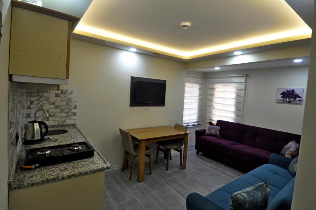 a living room with a couch and a table at Uzungöl Birlik Süite Hotel in Uzungol